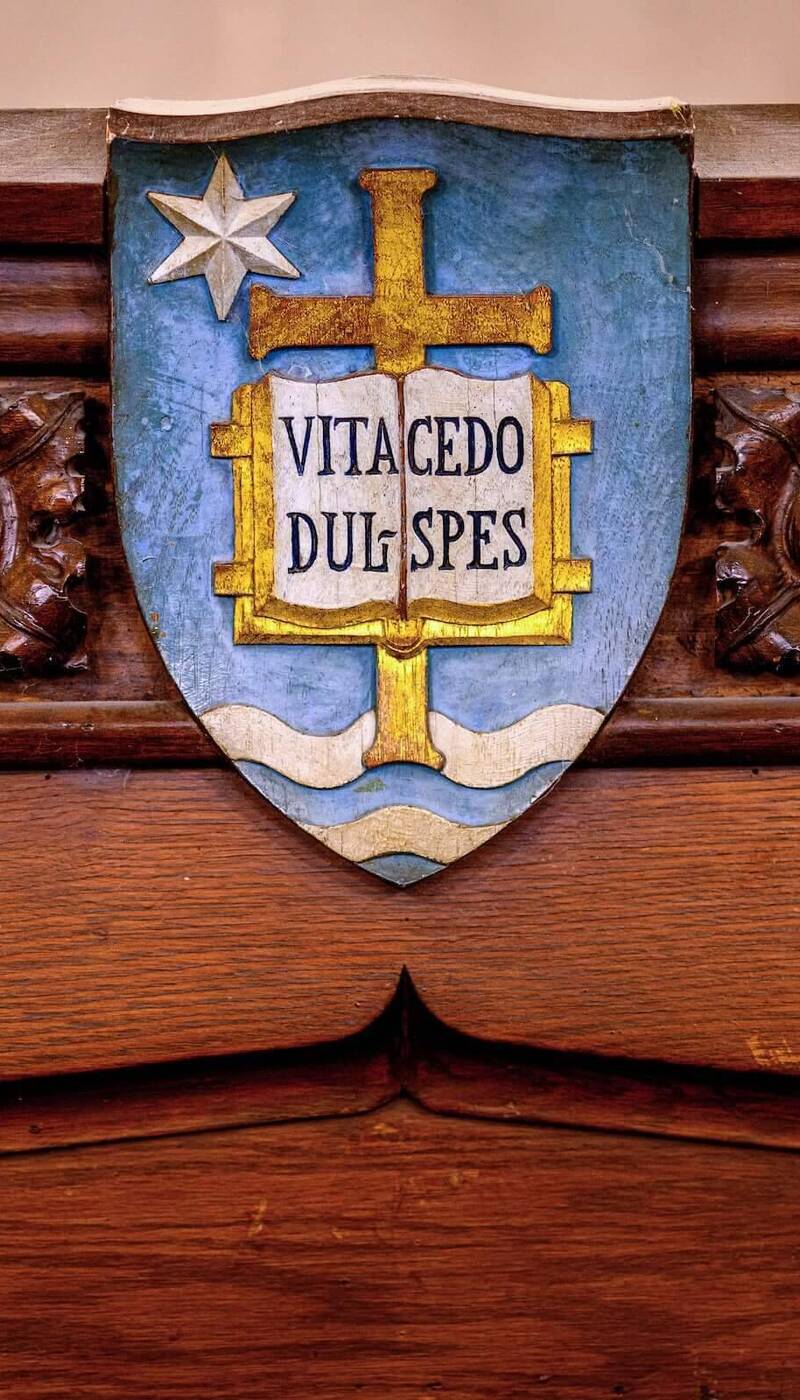 Notre Dame's blue and gold shield on ornate wood.